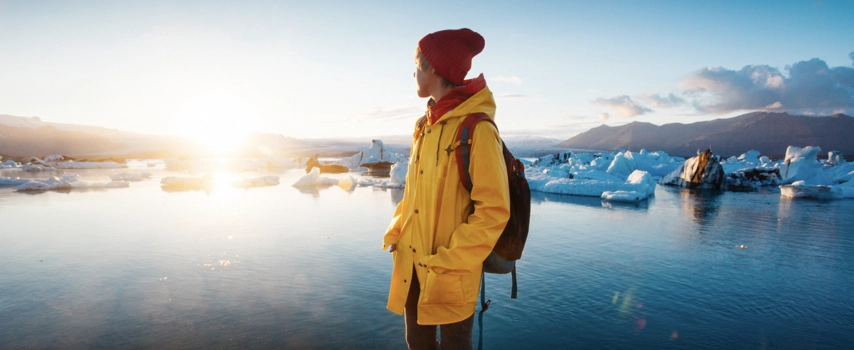 Woman with annual multi trip insurance cover looking Glacier Lagoon in Iceland