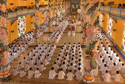 Colourful buildings and decorations stand in sharp contrast to the simple robes of those practicing their faith in Vietnam.This is a beautiful scene many first time visitors will enjoy.