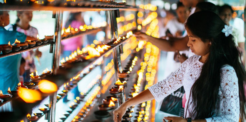 diwali lighting candles at temple